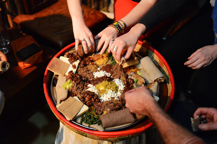 At the end of our first day, we shared a traditional Ethiopian meal.  Ethiopian food is meaty, spicy, shared communally, and there aren't any utensils; you eat with your hands.

There's something very intimate about sharing a meal this way, i think.  It feels like a wonderful way to seal new friendships.