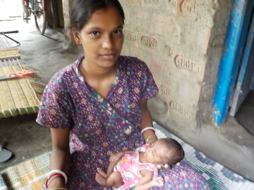 Teenage mother coddles a baby born at a low birth weight