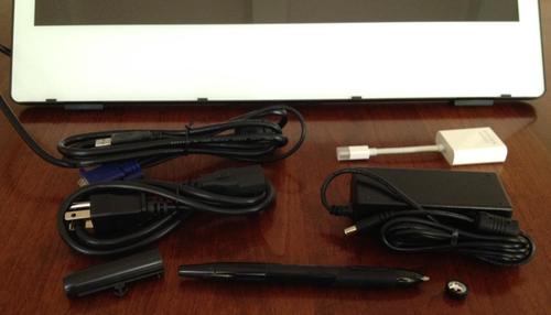Package contents, left-righ top-bottom: attached VGA, USB cable, 
miniDisplay to VGA adapter, power cord, power supply, pen holder, stylus, 
nib remover.