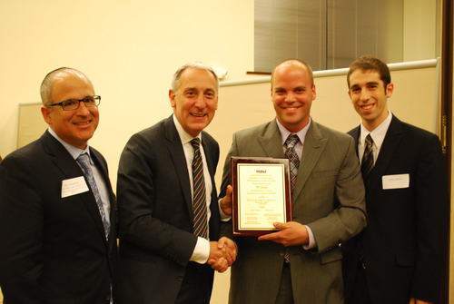 Click photo to download. Caption: Hillel CEO Eric Fingerhut, second from<br />left, on Oct. 10 presents the University of Illinois at Urbana-Champaign's<br />(UIUC) Illini Hillel with a plaque celebrating its 90th anniversary. UIUC<br />was the birthplace of the Hillel movement. Holding the plaque is Erez<br />Cohen, director of Illini Hillel. Credit: Hillel: The Foundation for Jewish<br />Campus Life.