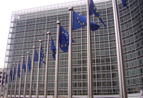 Click photo to download. Caption: European Union (EU) flags in front of the<br />European Commission building in Brussels. Credit: Amio Cajander via<br />Wikimedia Commons.