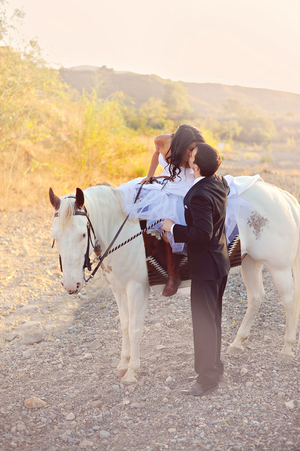  Sweet photo of a bride on a white horse kissing her groom | from Arina B Photography 