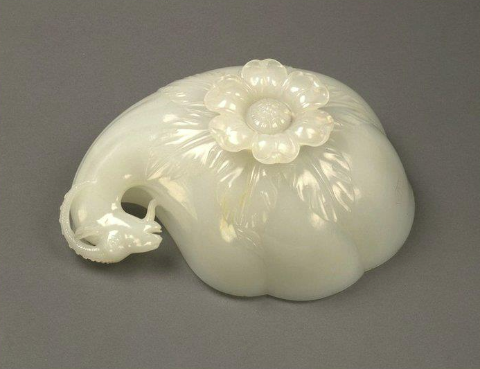 Mughal ruler Shah Jahan's Wine Cup. Jade. 1657. Jade cup carved in the form of a shell or gourd with carved handle terminating in the head of an Ibex & large floret shaped foot, left side underside view. This large cup is the finest known example of Mughal jade-carving. The Emperor's titles are carved on its side along with the date. Source: V&A Museum