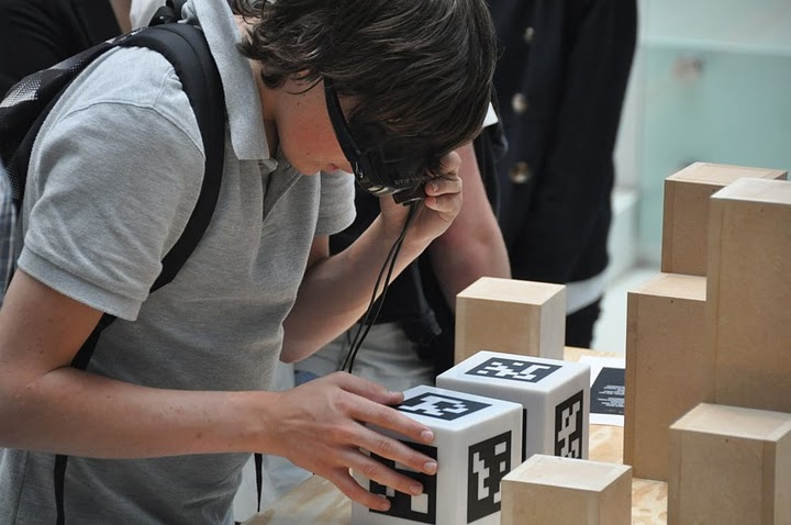 A student examines a box in the exhibition that is covered in AR tags. Image courtesy of the University of Groningen.