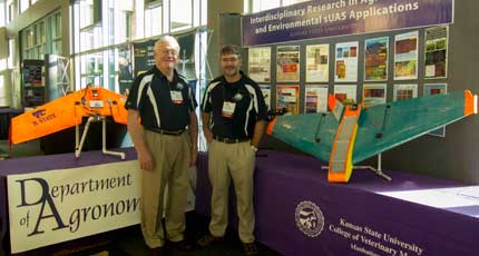 Kansas State University researchers Kevin Price (left) and Deon van der Merwe pose next to two of their small unmanned aircraft systems (UAS). The pair is part of a larger team that has been working on agricultural applications for UAS for the past two years. Photo courtesy of Kevin Price.