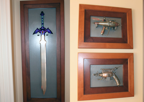 LEFT: We won a 2 of a kind Master Sword (made by Nintendo and used in a Zelda commercial) at a child charity event auction Nite2Unite.  RIGHT: Clifford's Dr. Grordbort's weapons he acquired at various Comic Cons. (These are right outside the game room, in the hallway.)