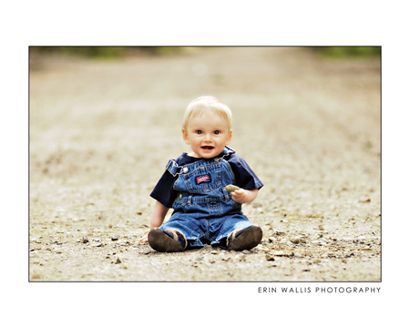 baby sitting on a dirt road