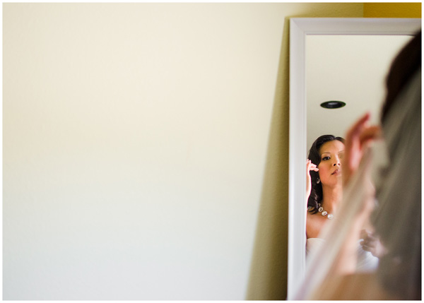 bride getting ready in mirror