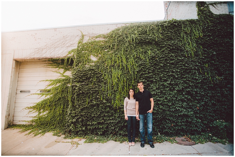 Downtown Omaha, NE engagement shoot with green ivy on building