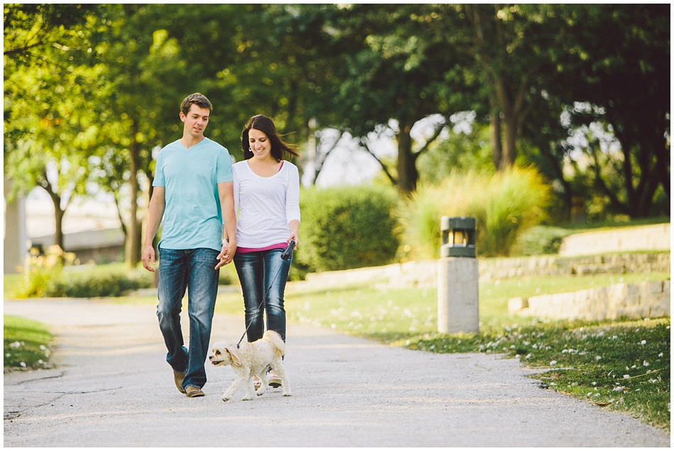 Couple walking their dog for engagement photos