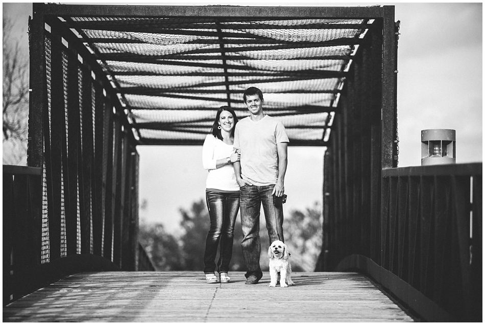 Black and white photo of couple on bridge for engagement photos