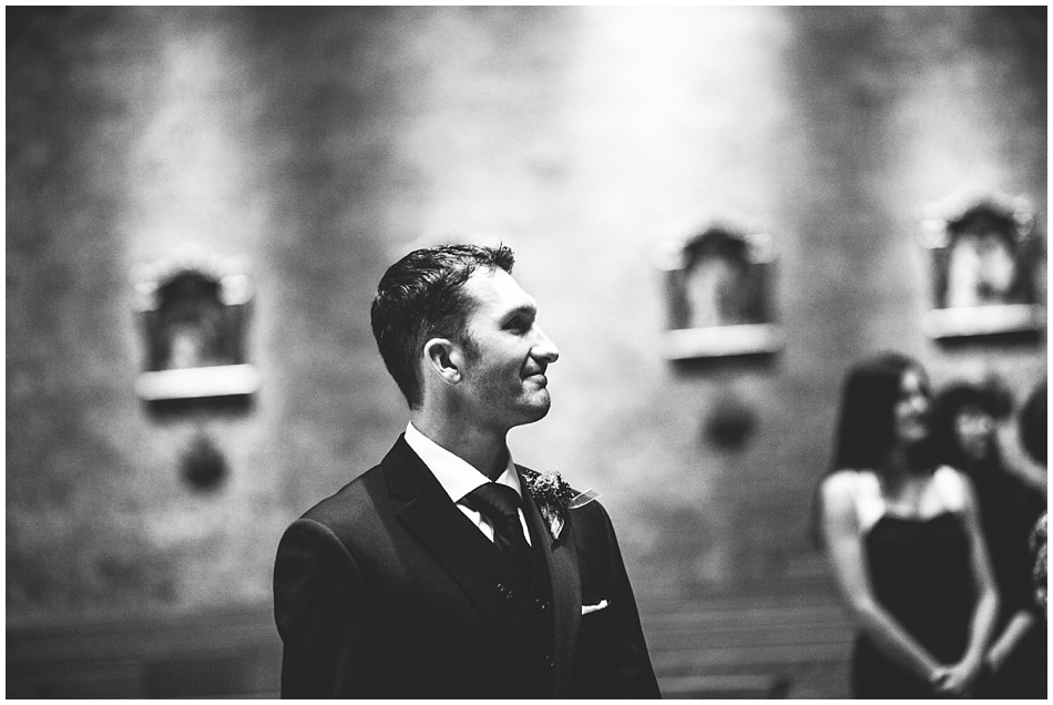 Groom looking at bride when walking down the aisle