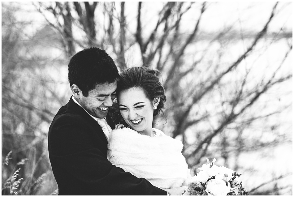 black and white photography bride and groom laughing
