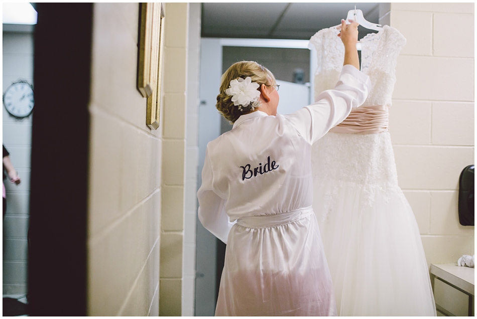 bride wearing robe with wedding dress