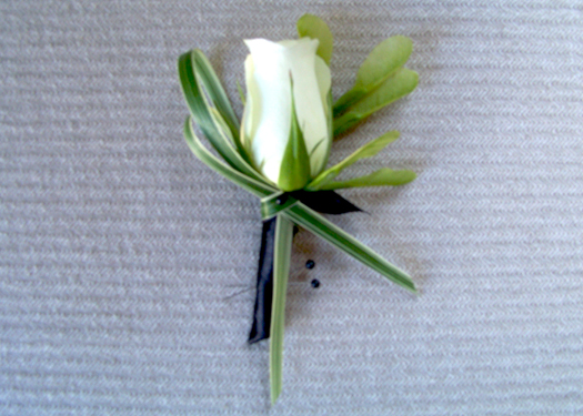 fathers' boutonnieres made up of an Akito rose, boxelder seeds and variegated lily grass