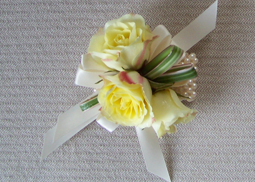 corsage with Lemoncello spray roses on an ivory pearl wristlet