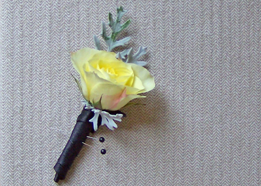 boutonniere with a single Lemoncello spray rose and dusty miller accents