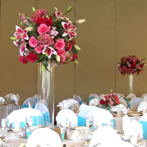 Tall centerpiece with Star Fighter oriental lilies, Hot Lady roses, Eliza roses, pink stock, pink lisianthus, pink/green antique hydrangea and seeded eucalyptus