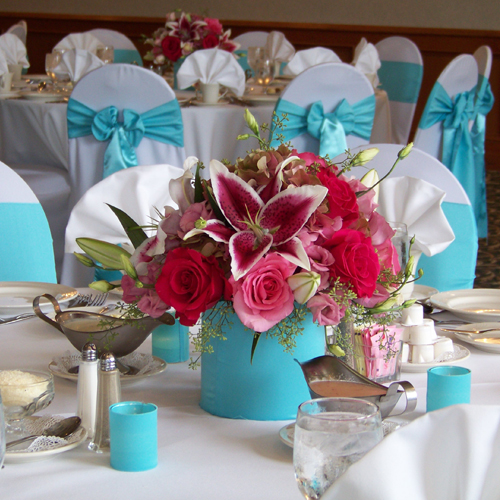 Low tiffany blue and pink centerpiece with Star Fighter oriental lilies, Hot Lady roses, Eliza roses, pink lisianthus, pink/green antique hydrangea and seeded eucalyptus