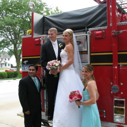 Kori and Eric pose with a fire truck