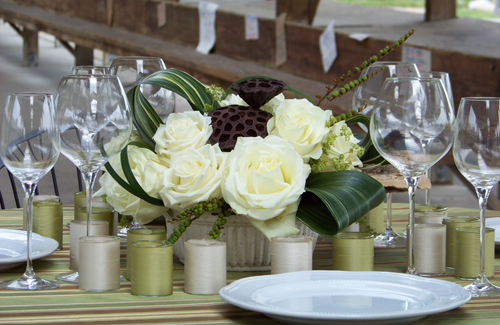 centerpiece with Polar Star roses, variegated aspidistra, montbretia pods, alchemilla, and lotus pods