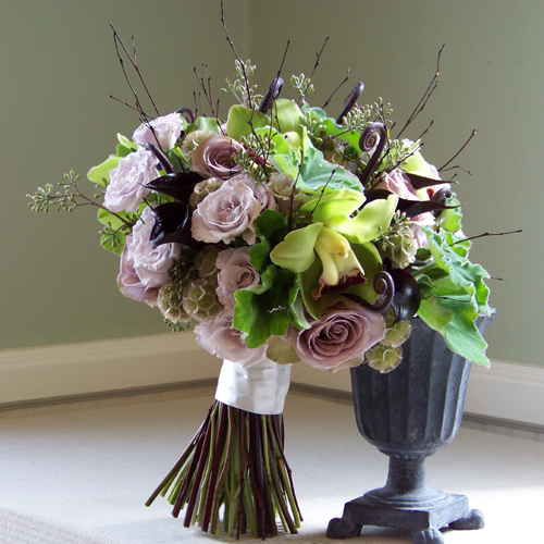 bridal bouquet with bamboo branches, fern curls, Schwartzwalder mini callas, Amnesia roses, Eloquence spray roses, scabiosa pods, seeded eucalyptus, cymbidium orchids and scented geranium