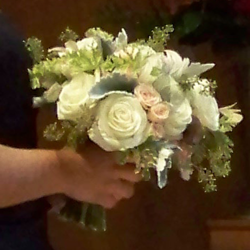 The bridal bouquet is held by the maid-of-honor during the ceremony