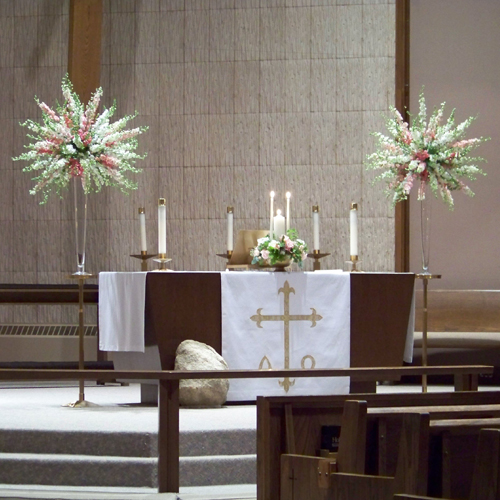 altar arrangements with pink and white snapdragons and larkspur