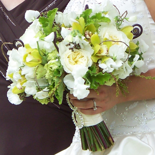 bridal bouquet with sweet peas, Patience garden roses, fern curls, curly willow, pieris buds, green hydrangea, green mini cymbidiums, scented geranium, seeded eucalyptus, Super Green roses, green minou spray roses, and Swarovski crystal accents