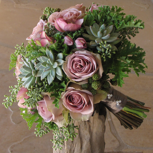 Hand-tied bridal bouquet with lavender hellebores, Amnesia roses, blackberries, Pachyveria glauca 'Little Jewel', seeded eucalyptus, and scented geranium, finished with a fawn satin wrap