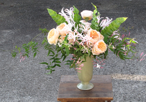 Centerpiece with Juliette garden roses, blush nerine lilies, pink tweedia, jasmine vine, and Asplenium ‘Crispy Wave’ foliage, by Floral Verde LLC, Cincinnati, OH.