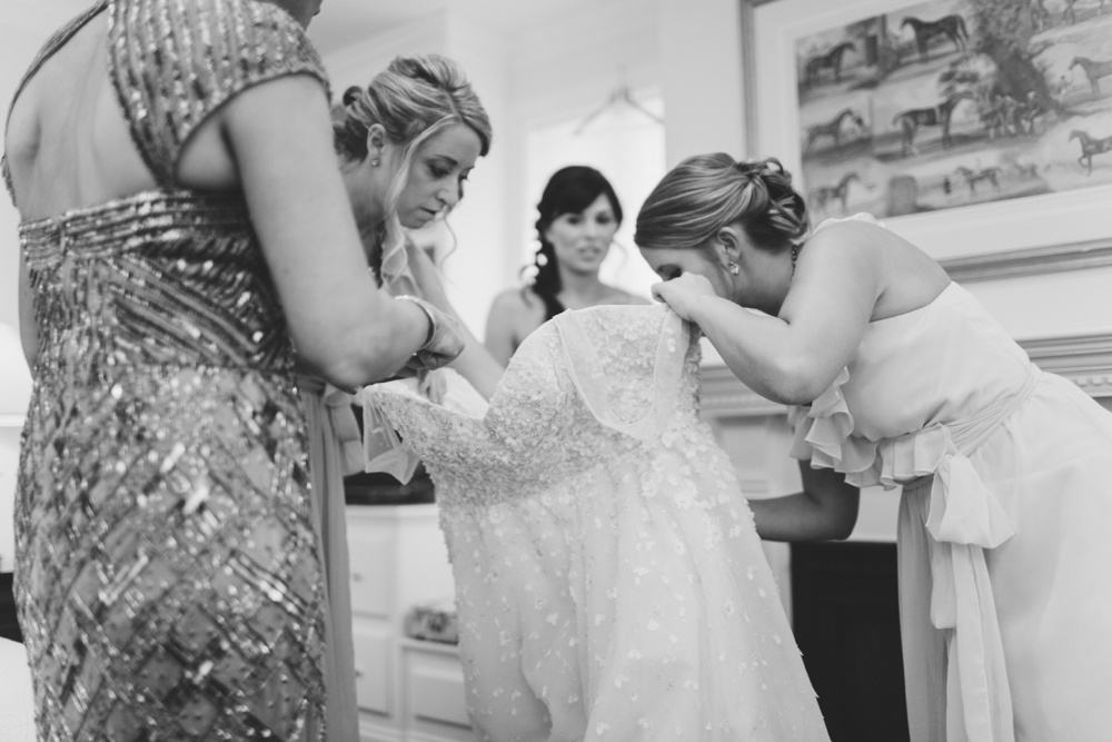 Bride getting into her Christos Wedding Dress for wedding at Terrain at Styers, Glen Mills Pennsylvania, Hair/Makeup: Beautiful Brides Philly, Philadelphia Wedding Photographers With Love & Embers