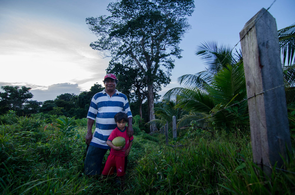 Jimmy and Grandson near his coconut farm, Ebo tree behind them - photo, Tom Miller