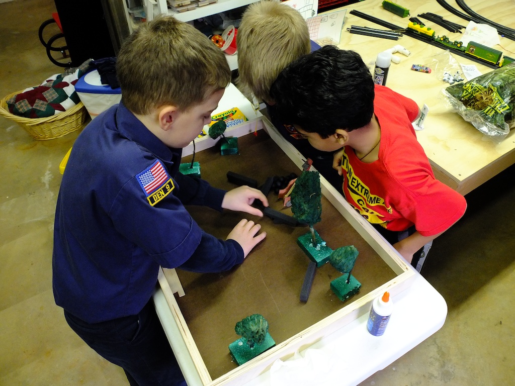Scouts plan the assembly of a diorama for their Bear badge