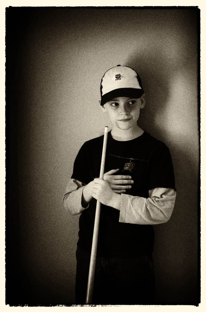 A boy plays his first game of pool...