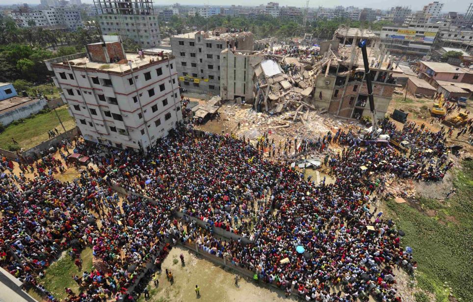 People gather in front of Rana Plaza building as rescue workers continue their operations, in Savar, 30 km (19 miles) outside Dhaka.
