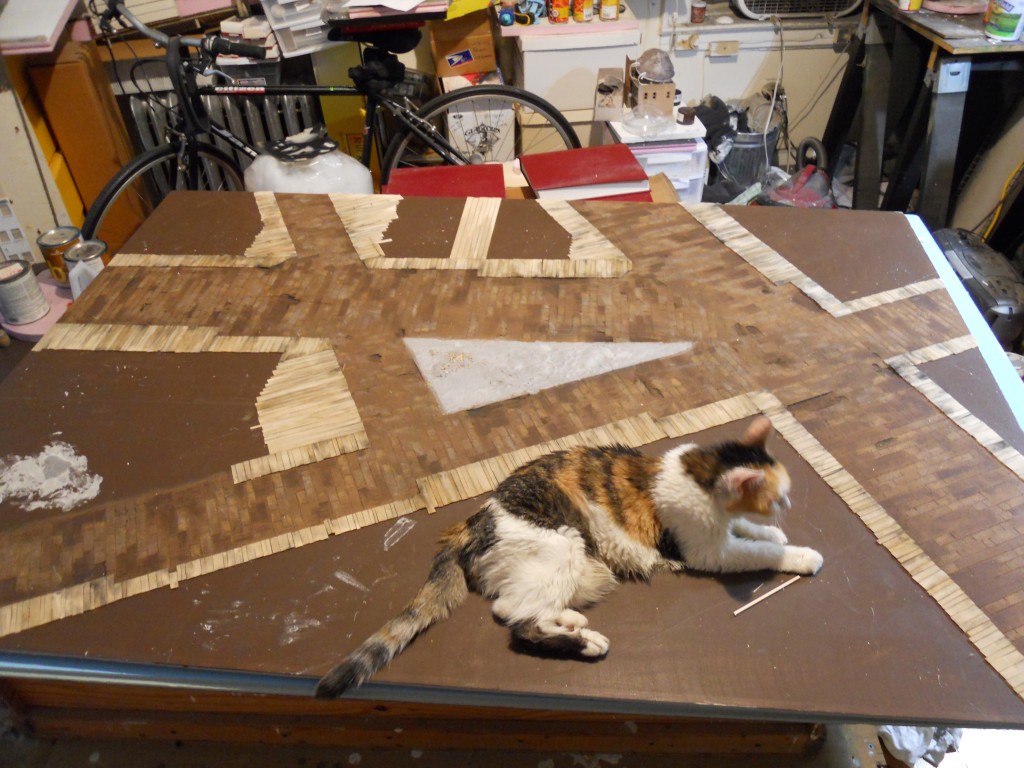 Laying out streets and wooden sidewalks for Five Points model. Daisy is keeping the board in place.