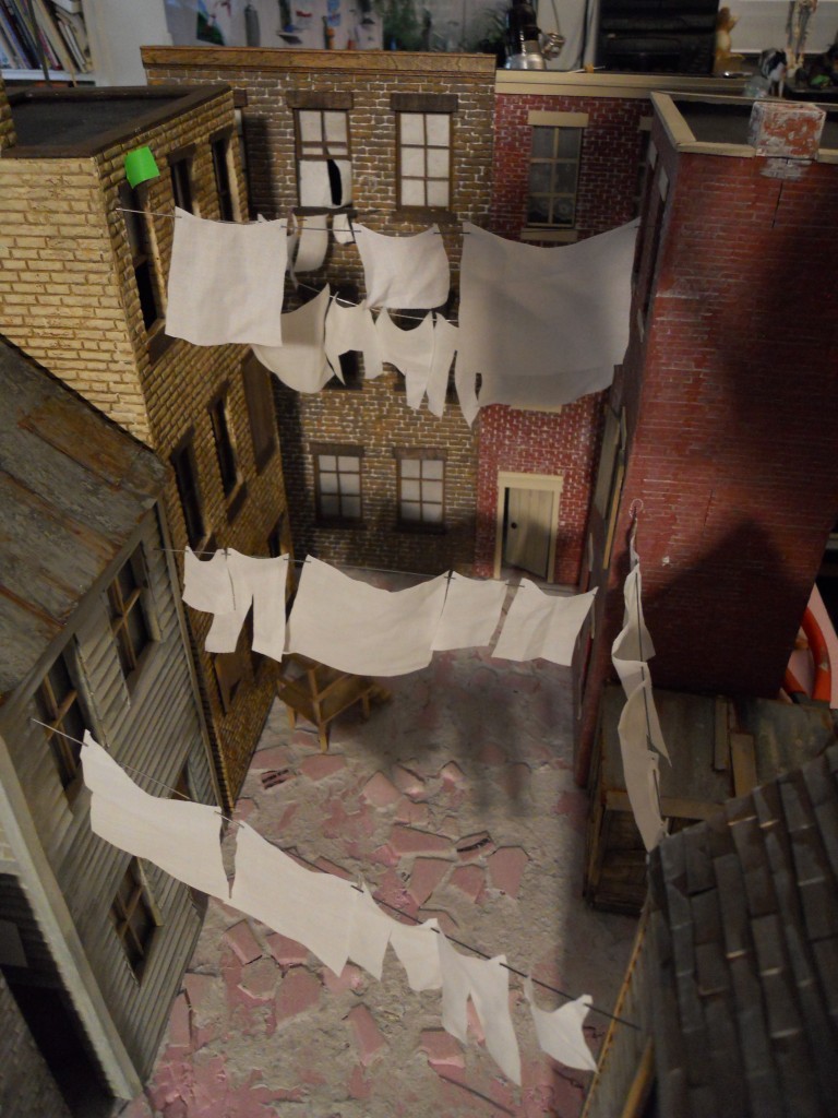 Birds-eye view of alley set up. Laundry is cut up dress shirt from the thrift store, hanging from piano wire.