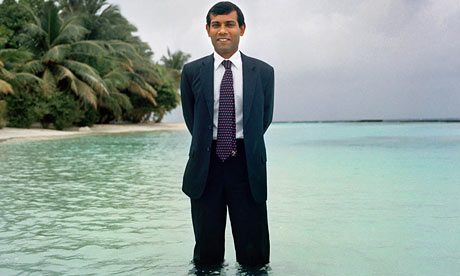 The Maldives president Mohamed Nasheed stands in the sea off Kurumba to show the threat the islands face. Photograph: Chiara Goia. Source: Guardian.
