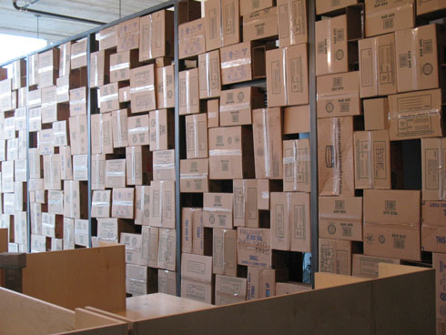 the randomly stacked boxes viewed from the desks