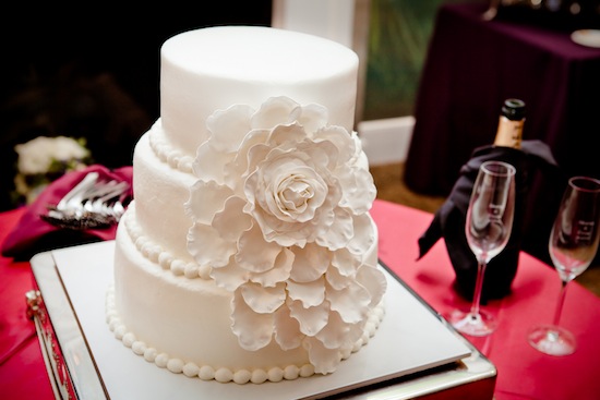 white wedding cake with large flower | photo by www.chiphotographyofcharleston.com