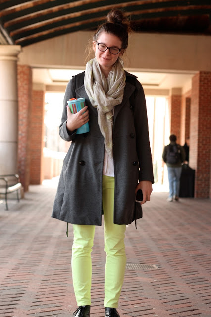 University of Georgia UGA student wears a gray rust rain jacket and a thin infinity scarf over green neon pants