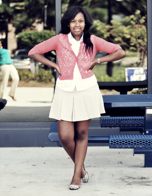 Savannah State University student is captured by photographer Cedric Smith wearing a simple pink cardigan over a white shirt and dress ensemble